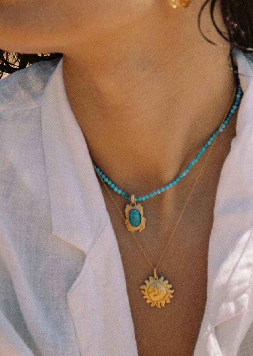 Turquoise choker with nefer charm and gold chain with a gold sun charm